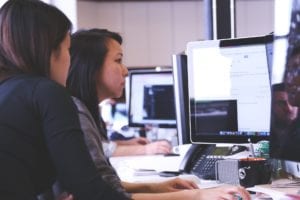 women analyzing data on computer screen