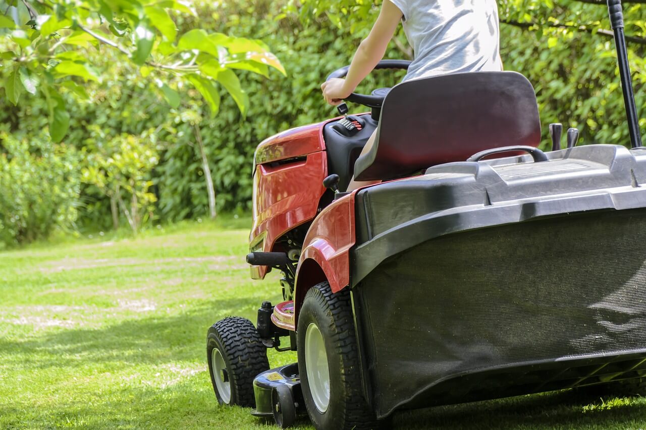 person on a lawnmower in spring